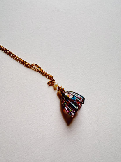 The Tulip Necklace features a 14k gold filled chain and a handblown glass tulip pendant in blue, pink, green, and purple hues, topped with a cultured freshwater pearl, shown on a white background.