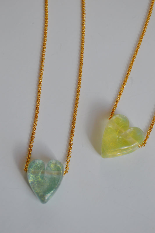 Two artisan jewelry gold-filled chains with handmade green lampwork glass heart pendants—Glass Heart Necklaces- Greens—are displayed on a plain white background.
