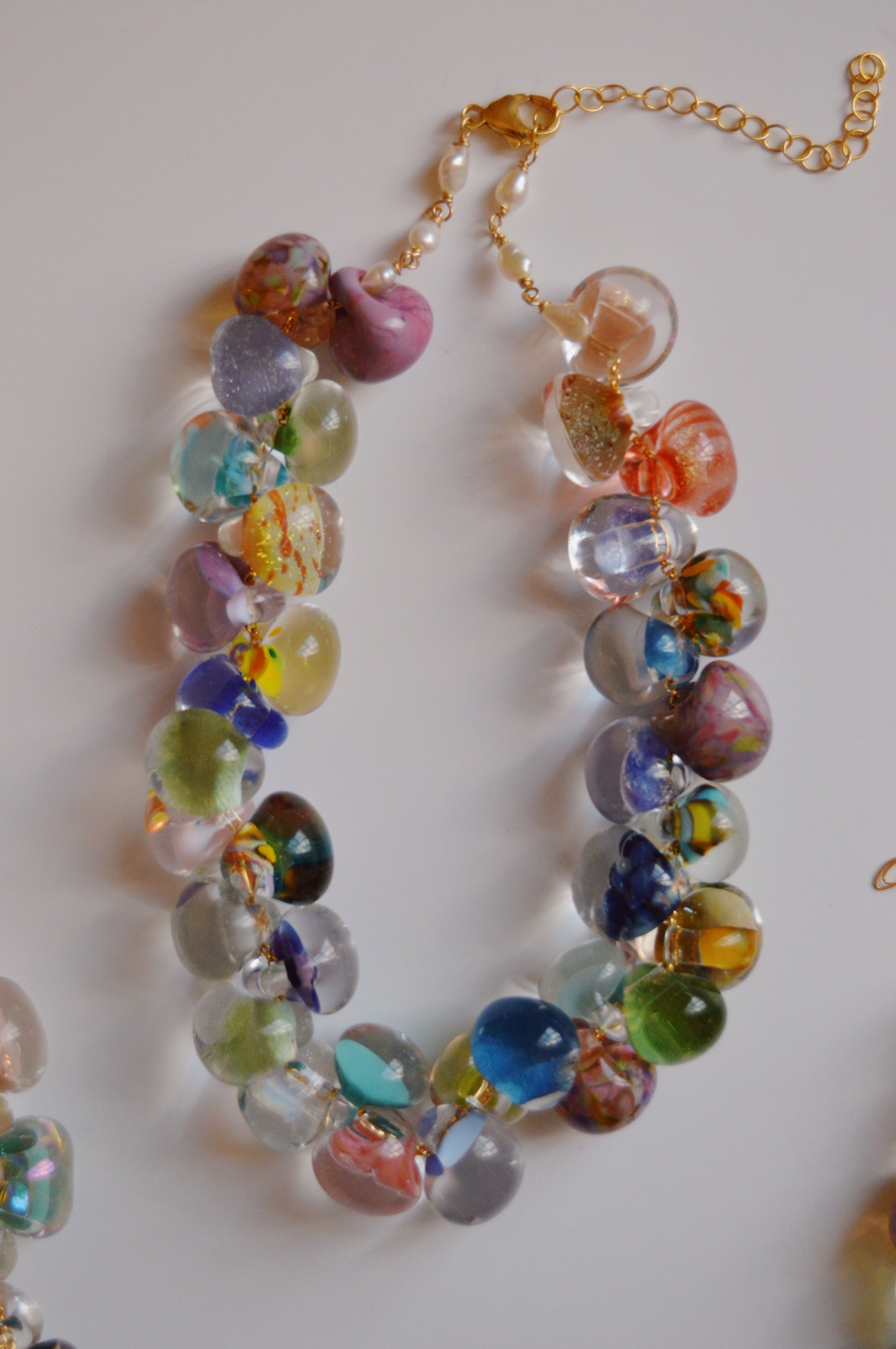 The Grand Bubble Necklace- Seaglass Mix features large, round handmade lampwork glass beads in translucent and opaque hues, connected by 14k gold-filled findings and clasp—a stunning handcrafted jewelry piece.