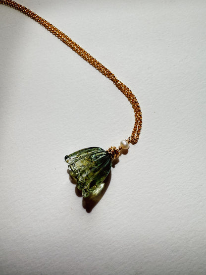 The Tulip Necklace features a green handblown glass tulip pendant and a small cultured freshwater pearl on a 14k gold filled chain, shown against a plain white background.