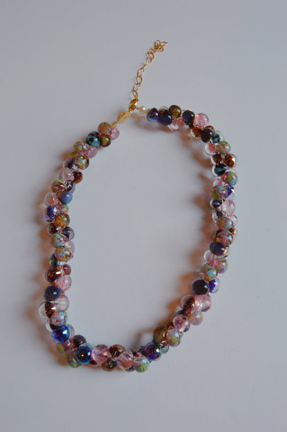 The Bubble Glass Necklace - Fall Mix features round, multicolored handblown glass beads in pink, purple, blue, and green with gold filled findings and an adjustable chain, displayed on a white background.