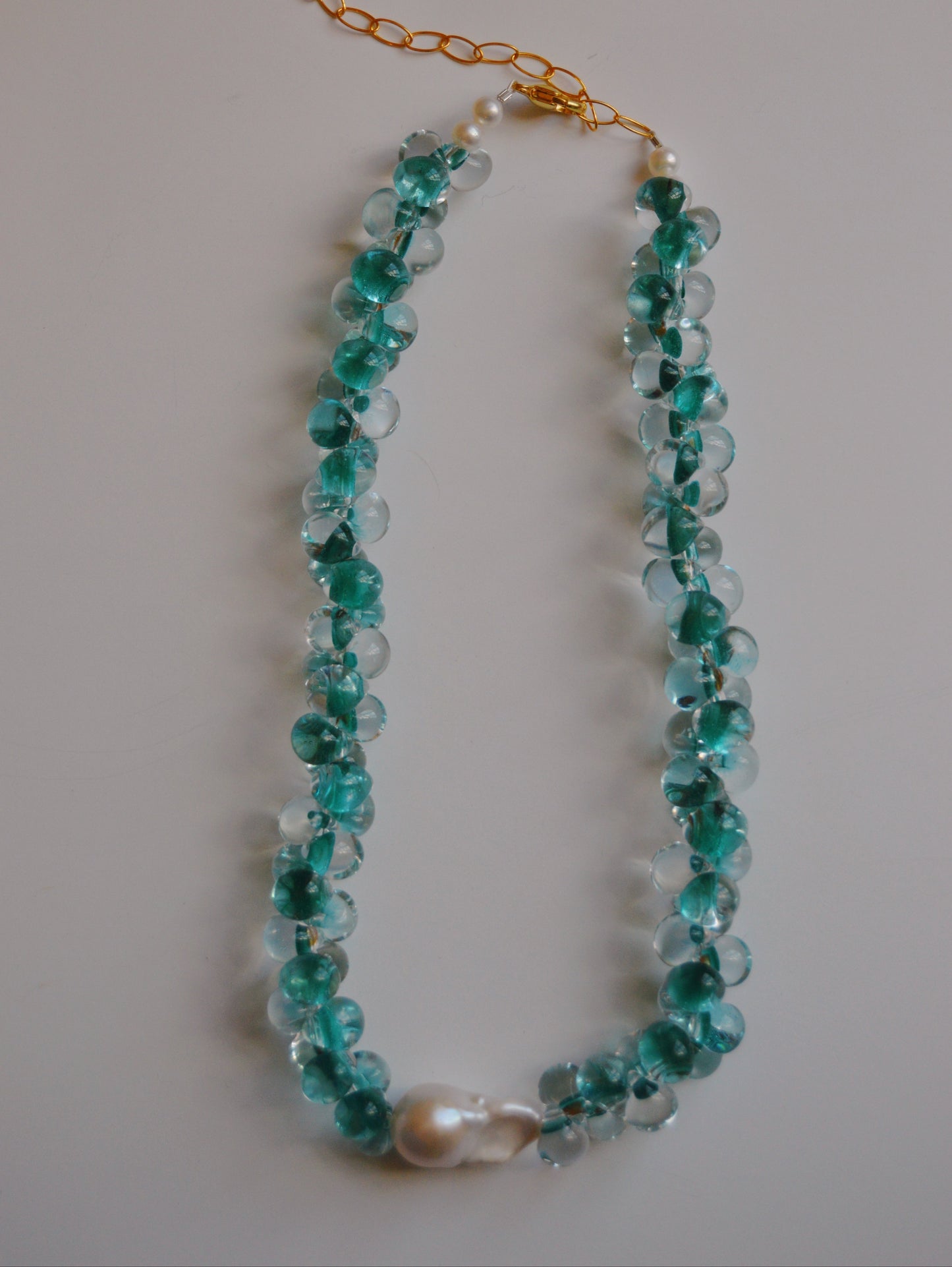 The Bubble Glass Necklace- Bora Bora features handmade translucent turquoise glass beads, a central large freshwater pearl, and gold-filled findings, displayed on a plain light background.