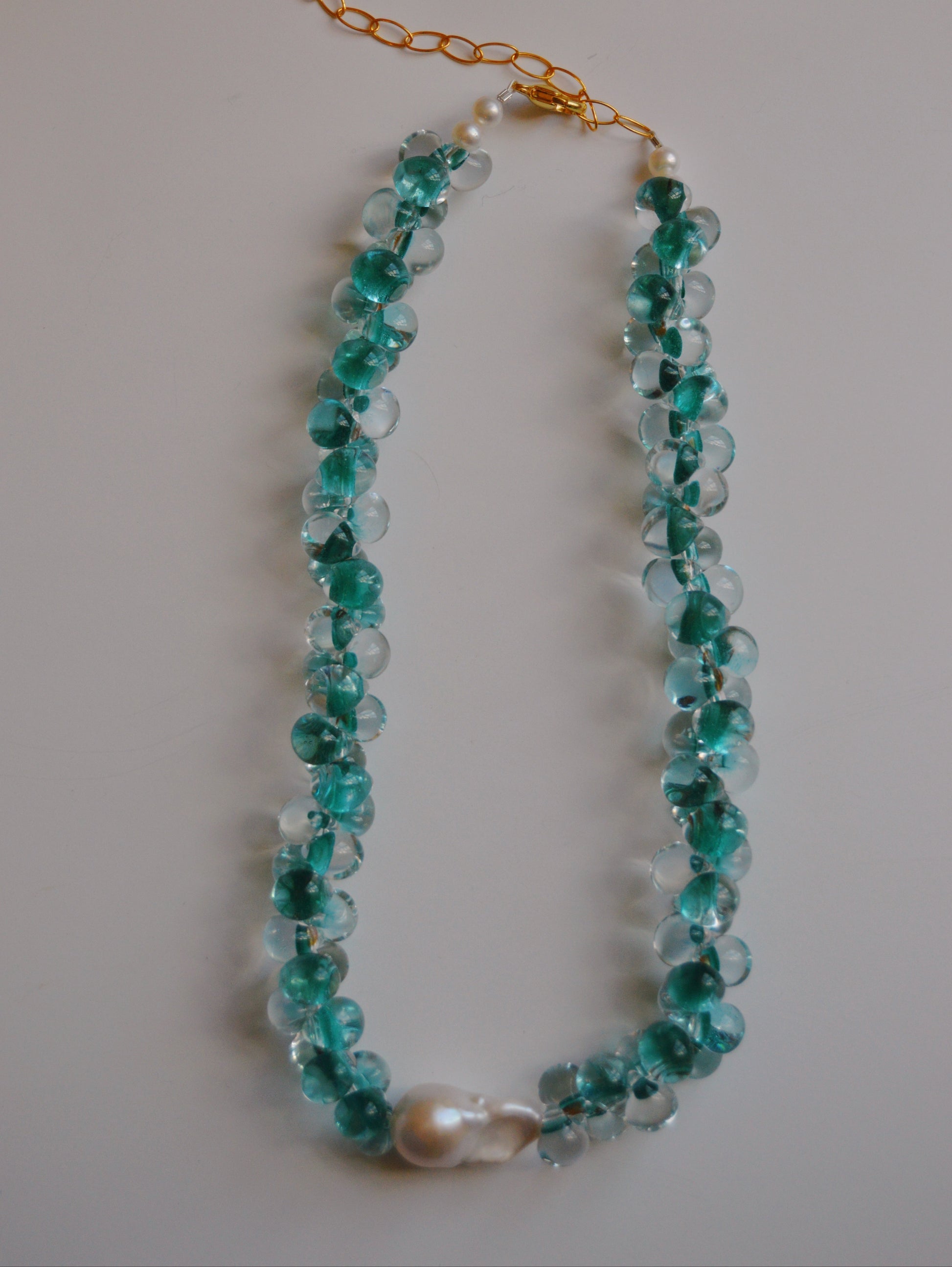 The Bubble Glass Necklace- Bora Bora features handmade translucent turquoise glass beads, a central large freshwater pearl, and gold-filled findings, displayed on a plain light background.