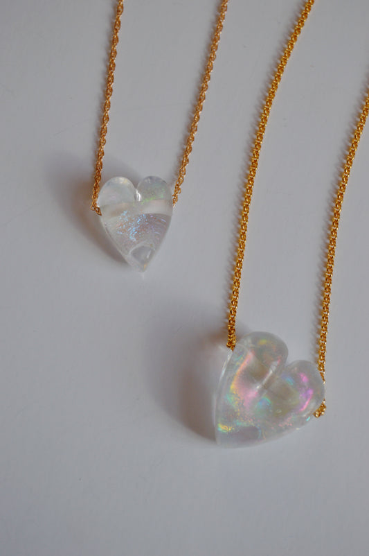 Two gold-filled chains each feature a clear, iridescent glass heart pendant from the Glass Heart Necklaces- Whites and Clears collection, shown on a white background.