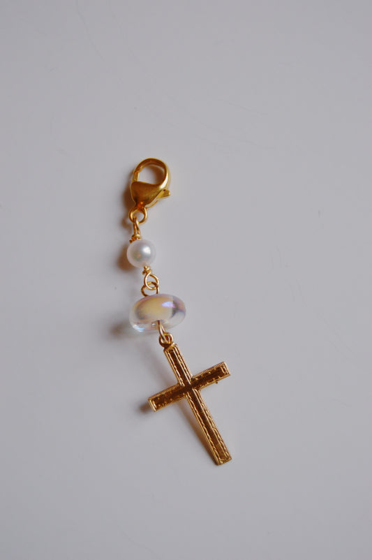 The Glass and Cross Charm keychain features a gold lobster clasp, a small white pearl, a clear handmade lampwork glass bead, and a 14k gold filled cross pendant. Shown on a plain white background.