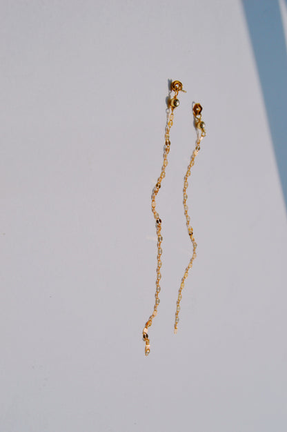 The Sway Studs are delicate 14k gold filled earrings adorned with small beads, displayed on a white background with gentle shadows.