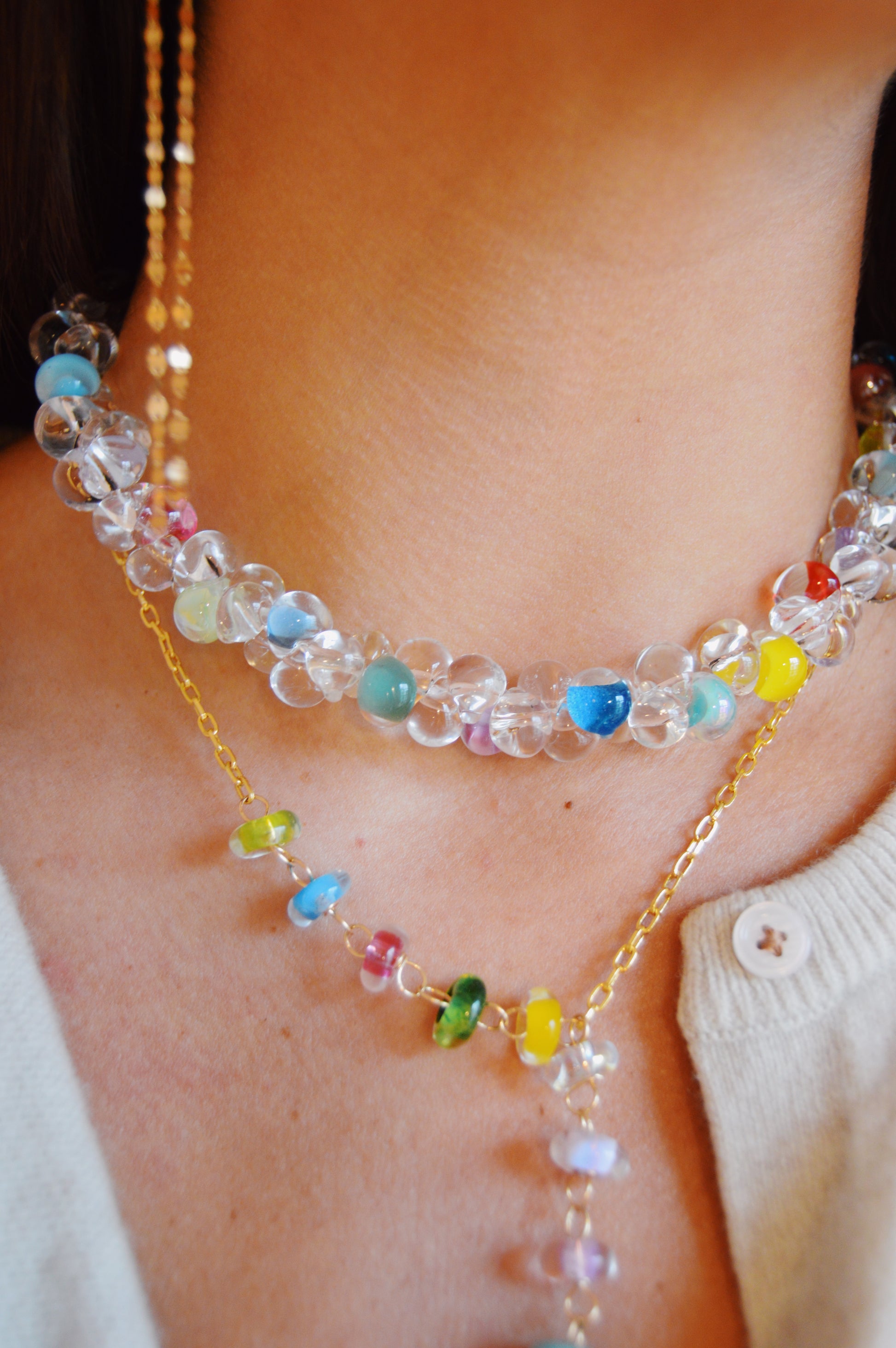 A woman wears the Valentine Bubble Glass Necklace- Sprinkles around her neck.