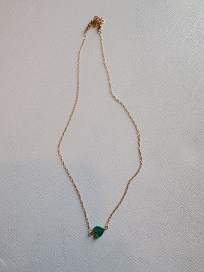 The Boyfriend Necklace—a delicate gold filled chain with a small green stone pendant—is displayed on a light textured surface, perfect for fans of gold filled jewelry.