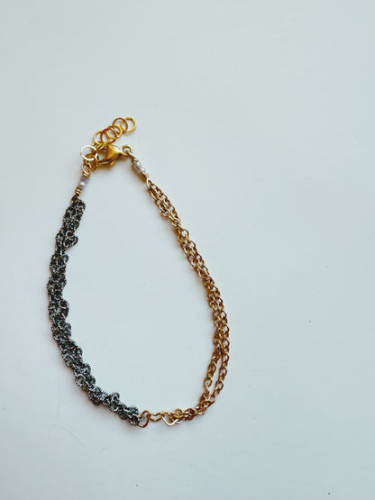 The 2026 Winterfest Bracelet features two 14k gold filled chains and one black oxidized sterling silver chain, joined by a gold clasp and showcased on a plain white background.
