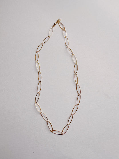 The Gold Filled Almond Layer is a delicate 14k gold filled chain necklace featuring elongated oval links, displayed on a light background.