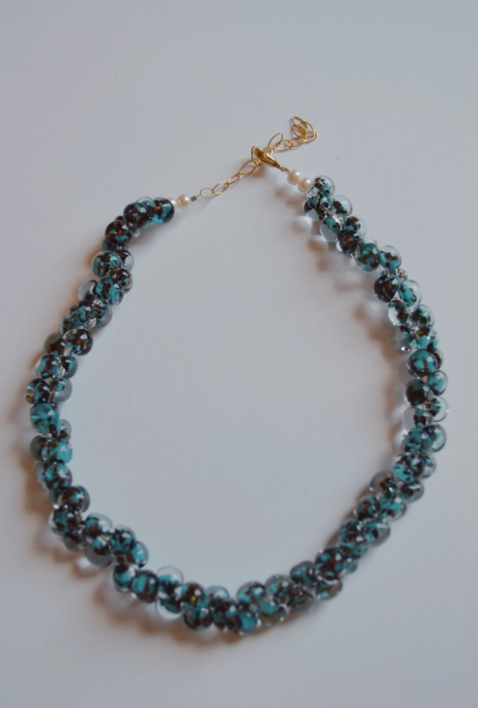 The Print Bubble Glass Necklace features blue and black glass beads with 14k gold-filled accents.