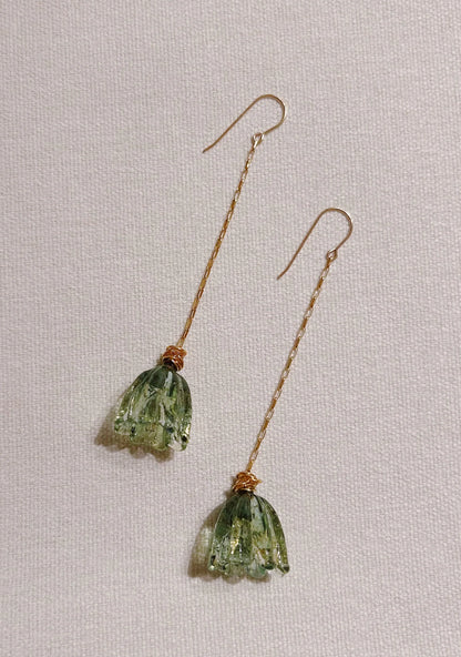 Glass Tulip Earrings in jade feature long gold hooks and delicate, translucent handmade tulip details, expertly crafted by skilled glass artists and shown on a light textured background.