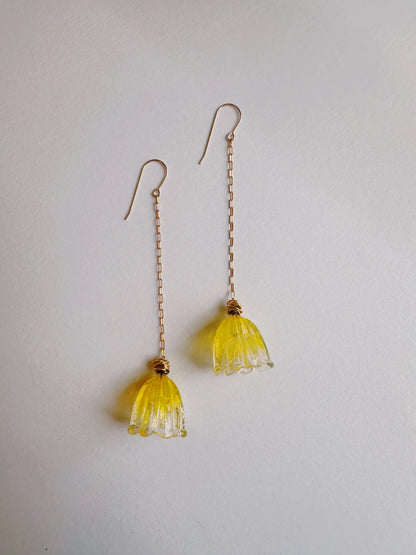 Glass Tulip Earrings in lemon color feature long, thin 14k gold-filled chains with handmade yellow lampwork tulips by a glass artist at the ends, shown on a plain white background.