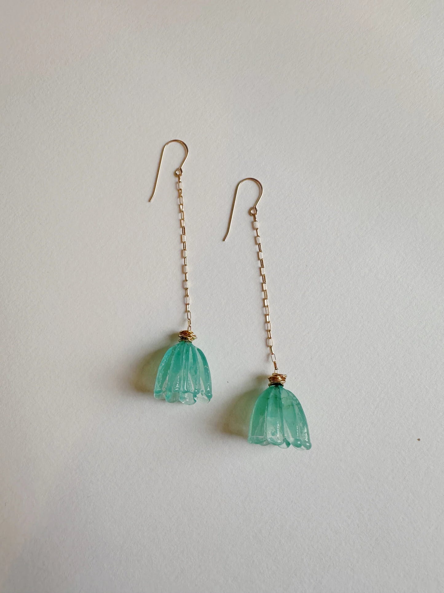 Glass Tulip Earrings in Seaside: long 14k gold-filled chains with handmade light blue-green lampwork tulip charms, shown on a plain white background.